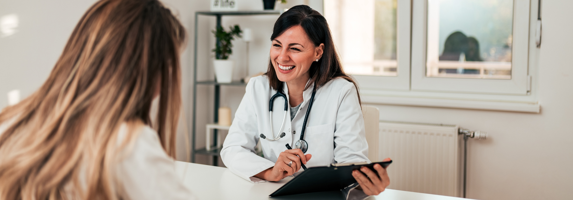 Young doctor and patient talking in the doctor's office.